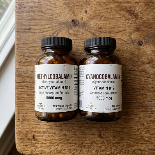 Two Vitamin B12 bottles side by side comparing methylcobalamin and cyanocobalamin formulas, both 5000 mcg.