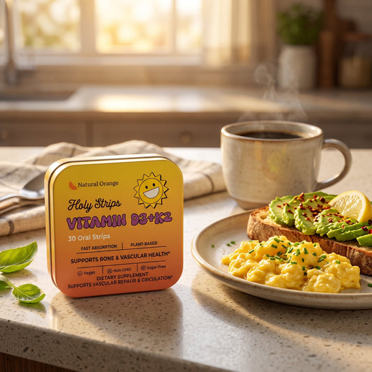 Holy Strips Vitamin D3+K2 tin standing on a kitchen counter beside a plate of avocado toast, scrambled eggs, and a mug of coffee.