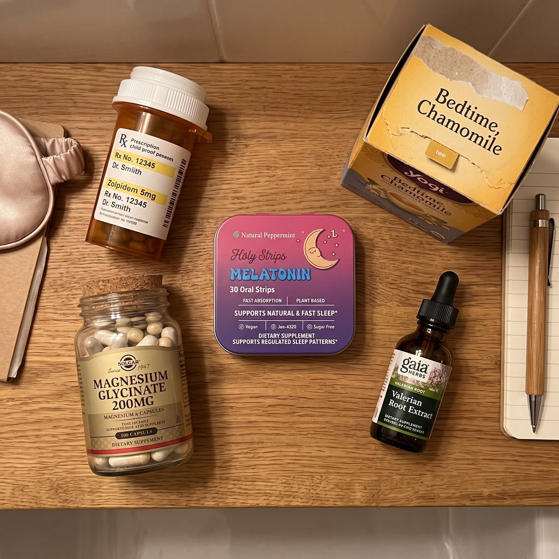 Overhead flat-lay comparing sleep products, including a prescription Zolpidem bottle, chamomile tea, a Holy Strips Melatonin tin, magnesium glycinate, valerian root extract, and a sleep mask.