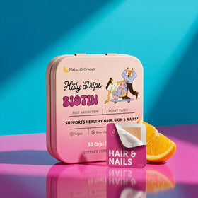 A pink tin labeled “HolyStrips® Biotin” from Holy Strips is shown alongside an orange slice and a “Hair & Nails” card against a vibrant blue and purple background, showcasing these fast-dissolving oral vitamin biotin strips designed to support hair, skin, and nails.