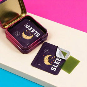 A metal tin and a packet labeled “SLEEP” with a moon design, featuring HolyStrips® Melatonin Strips from Holy Strips, and showing a green translucent sleep strip being peeled off on a color-blocked background.